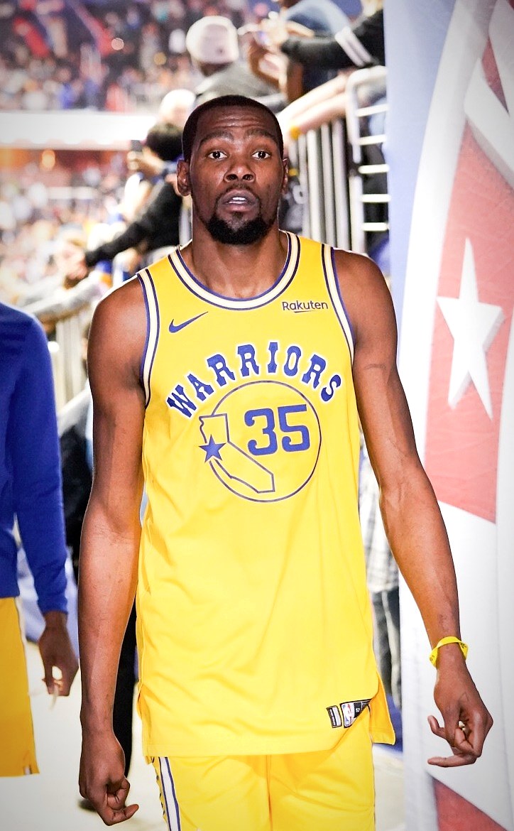 Kevin Durant with the Golden State Warriors, whose career contract decisions became a defining case study in how the NBA salary cap and luxury tax shape roster construction